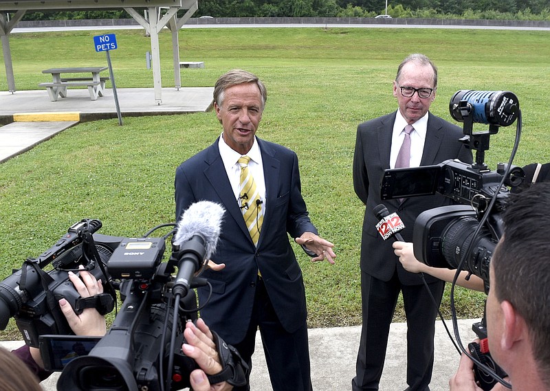 Gov. Bill Haslam speaks to the media while Transpoertation Commissioner John Schroer looks on.  Tennessee Gov. Bill Haslam  signed the IMPROVE Act Bill at the Tennessee Welcome Center in East Ridge, Tenn. on June 4, 2017.  