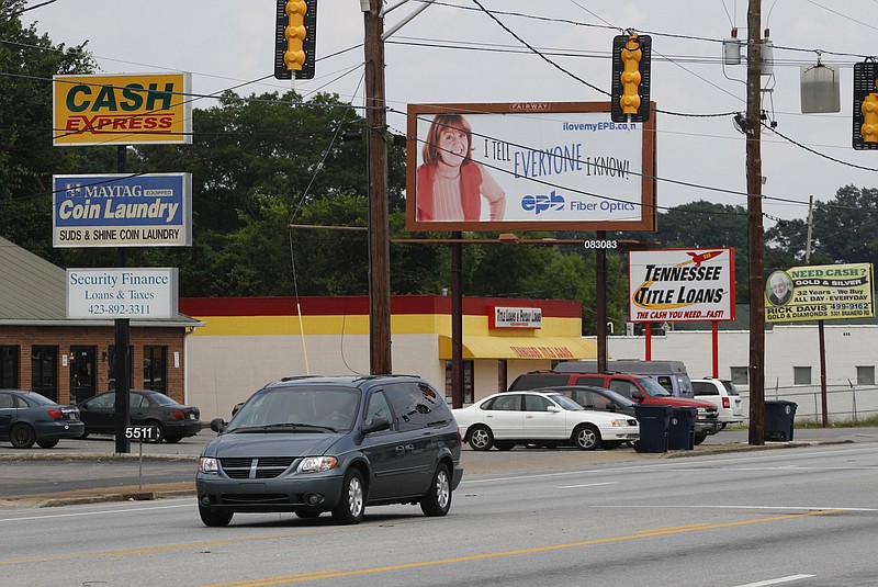 A motorist passes numerous loan service businesses off of Ringgold Road in East Ridge on Monday. Chattanooga has a high number of payday lenders. 