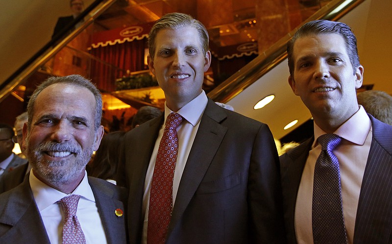 
              Eric Danziger, CEO of Trump Hotels, left, joins Eric Trump, center, and Donald Trump Jr., both of whom are executive Vice Presidents of The Trump Organization, as the trio poses for a photograph during an event for Scion Hotels, Monday, June 5, 2017, in New York. (AP Photo/Kathy Willens)
            
