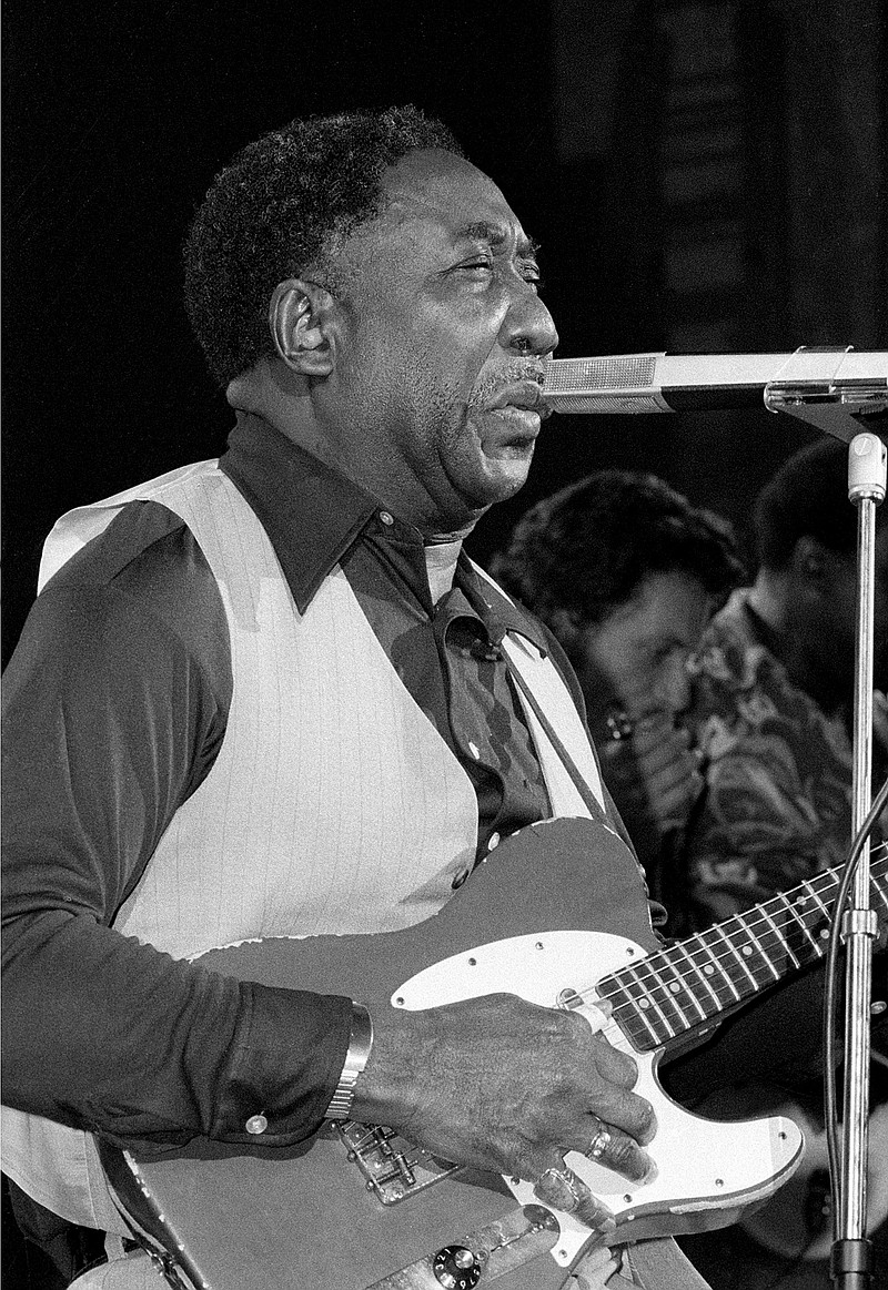 
              FILE - In this Oct. 1, 1977, file photo, blues musician Muddy Waters performs at New York's Palladium Theater. The city of Chicago plans to dedicate nine-story mural to the blues legend on Thursday, June 8, 2017, before the city's annual blues festival this weekend. Waters is known as the father or king of Blues music in Chicago. He died in 1983 outside Chicago at age 70. (AP Photo/File)
            