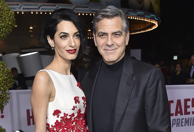 
              FILE - In this Feb. 1, 2016 file photo, Amal Clooney, left, and George Clooney arrive at the world premiere of "Hail, Caesar!" in Los Angeles.  George and Amal Clooney have welcomed twins Ella and Alexander Clooney. The pair was born Tuesday morning, June 6, 2017, according to George Clooney’s publicist Stan Rosenfield.  (Photo by Jordan Strauss/Invision/AP, File)
            