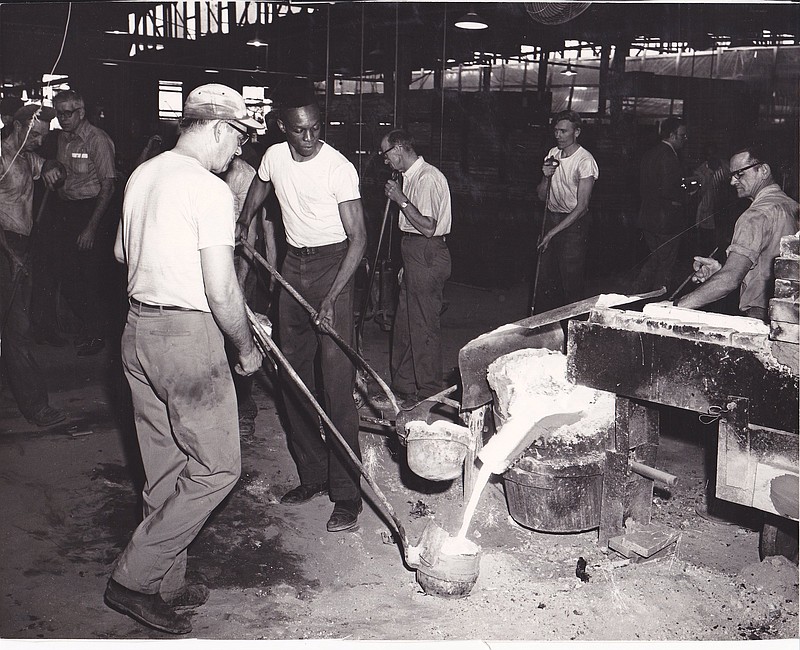 Foundry workers catch molten iron in ladles at the Magic Chef foundry, previously Dixie Foundry, in the 1970s. The photo is part of a new exhibit, "Heating Up! The Story of Stoves," which opens to the public Friday at Museum Center at Five Points.