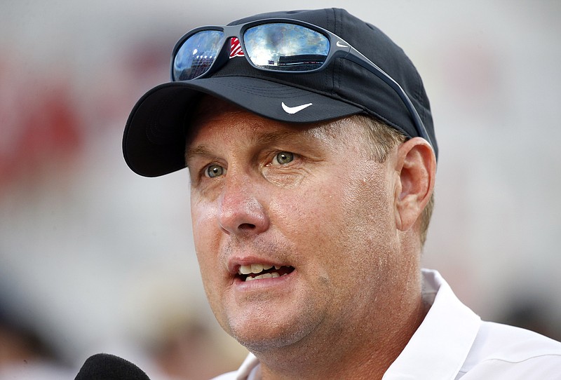 
              FILE - In this Saturday, Sept. 10, 2016 file photo, Mississippi head coach Hugh Freeze speaks with a reporter about the team's 38-13 win over Wofford in their NCAA college football game in Oxford, Miss. The University of Mississippi has contested the NCAA’s charges of lack of institutional control and failure to monitor by head coach Hugh Freeze. The Ole Miss football program released its response Tuesday, June 6, 2017 to a second NCAA Notice of Allegations in less than two years. The first NOA alleged 13 violations while the second added eight more, bringing the total to 21. (AP Photo/Rogelio V. Solis, File)
            
