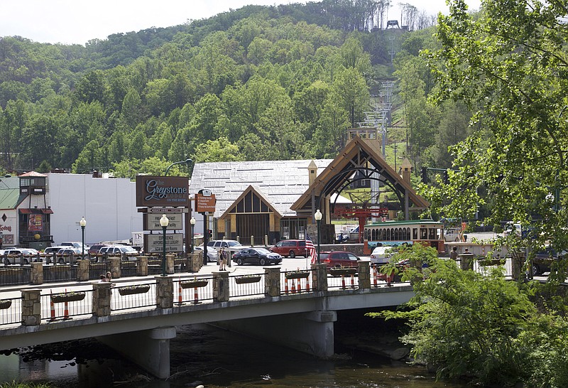 
              In this May 20, 2017 photo, a new chairlift attraction is under construction in downtown Gatlinburg, Tenn. A deadly wildfire in November of 2016 put a dent in the tourism industry, but signs of growth are returning. (AP Photo/Kristin Hall)
            