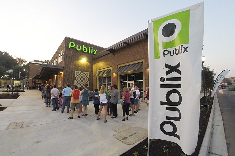 Staff Photo by Dan Henry / The Chattanooga Times Free Press- 8/6/14. A line wrapping around the store forms as customers wait for Chattanooga's newest Publix Supermarket to open its doors at 7am on Wednesday, August 6, 2014. The first 50 customers received a free bag of groceries valued at $25 from the North Shore store.  