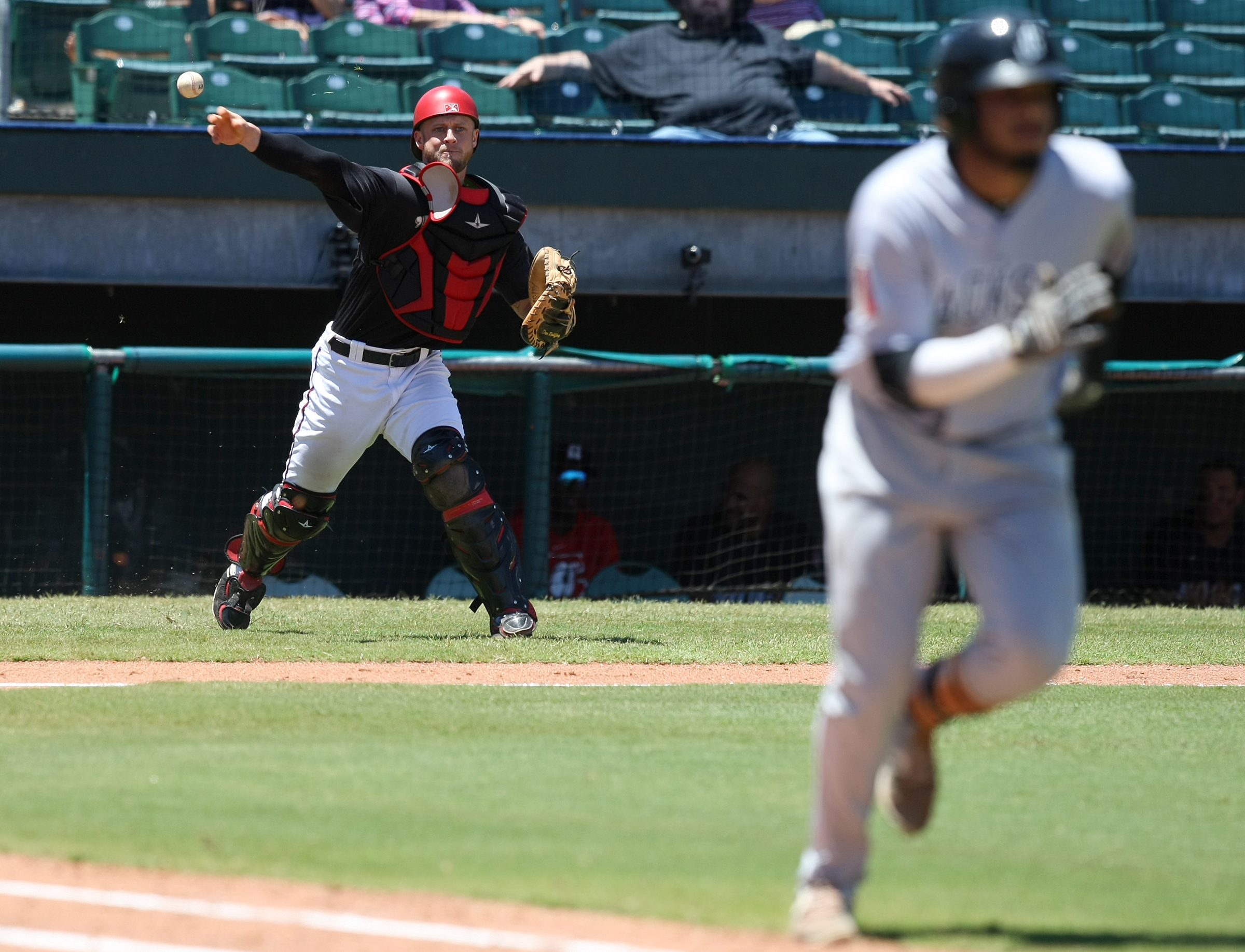 Chattanooga Lookouts catcher Dan Rohlfing (8) throws out Jackson Generals third baseman Dawel Lugo (31) at first base during the top of the sixth inning at AT&T Field on Wednesday, June 7, in Chattanooga, Tenn.