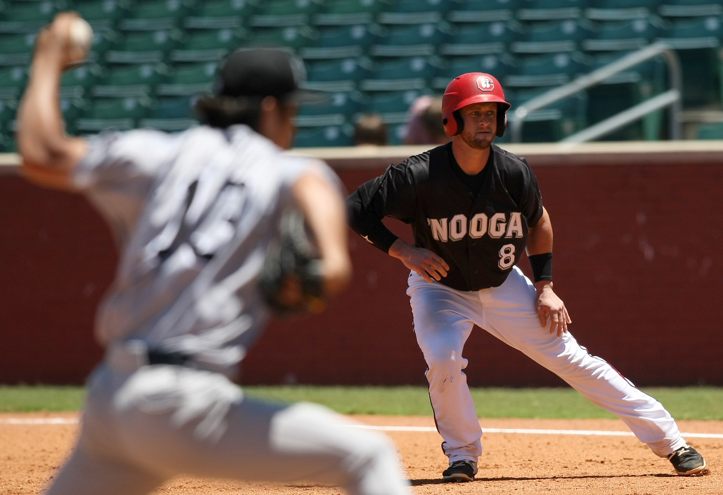Chattanooga Lookouts catcher Dan Rohlfing (8) leads off from first base as Jackson Generals pitcher Yuhei Nakaushiro (13) pitches in the bottom of the sixth inning at AT&T Field on Wednesday, June 7, in Chattanooga, Tenn.
