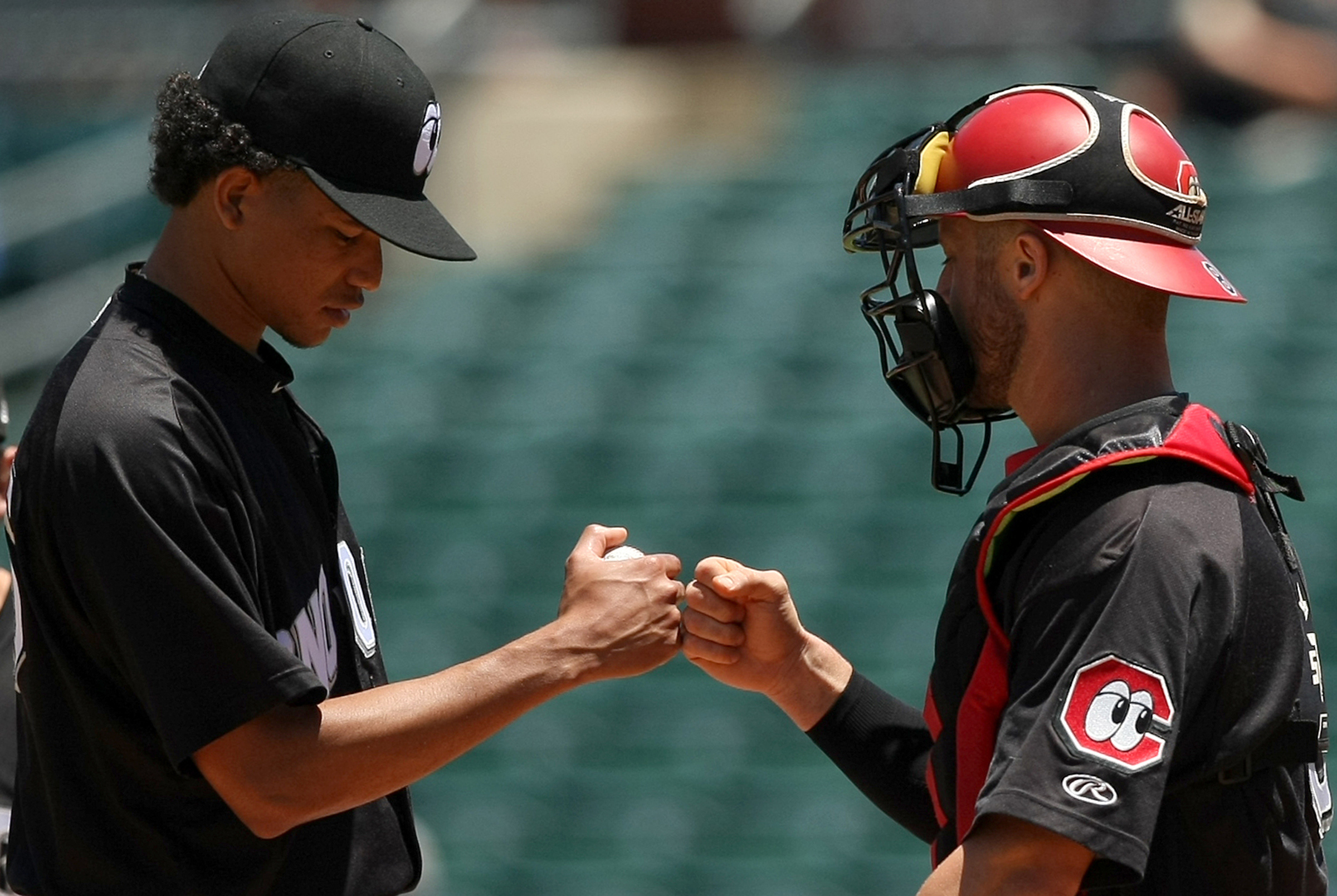 Chattanooga Lookouts pitcher Felix Jorge bumps fists with catcher Dan Rohlfing after being pulled in the seventh inning of Wednesday's game against the Jackson Generals at AT&T Field. The Lookouts won 7-2 in a game that started before noon and came after a 14-inning loss for the hosts.
