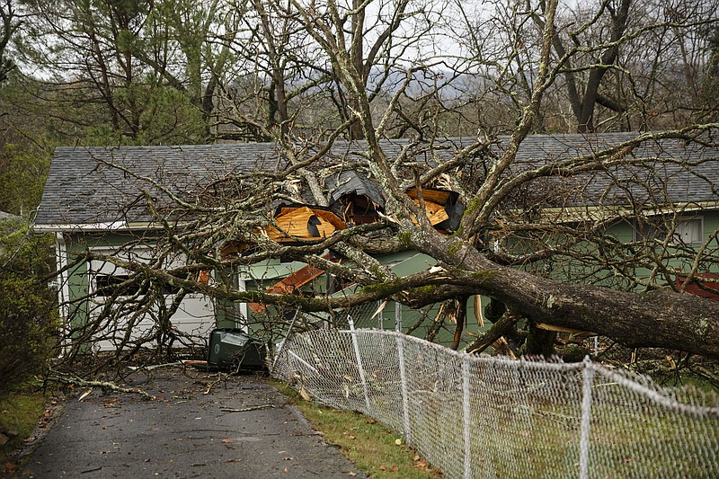 A tree fell onto a home between Westwood Avenue and Highland Drive on Wednesday, March 1, 2017, in Chattanooga, Tenn. Severe storms swept through the region Wednesday afternoon.