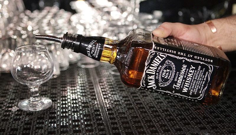 
              FILE - In this March 4, 2011, file photo, a bartender begins to pour a drink from a bottle of Jack Daniels at a bar in San Francisco. Spirits maker Brown-Forman Corp. (BF.A) on Wednesday, June 7, 2017, reported fiscal fourth-quarter earnings of $144 million. (AP Photo/Paul Sakuma, File)
            