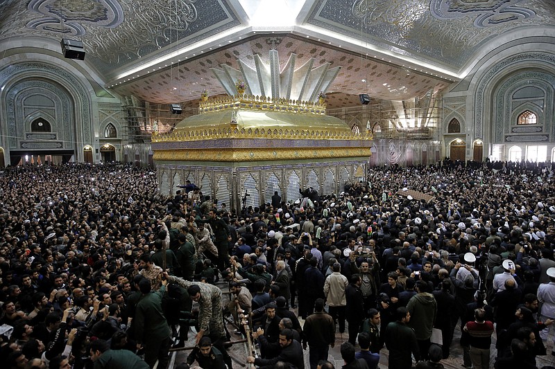 In this Jan. 2017, file photo, mourners carry the coffin of former Iranian President Akbar Hashemi Rafsanjani during his burial at the shrine of the late revolutionary founder Ayatollah Khomeini just outside Tehran, Iran. State TV said Wednesday, June 7, 2017 that four 'terrorists,' including suicide bomber, attacked the Khomeini shrine. (AP Photo/Ebrahim Noroozi, File)