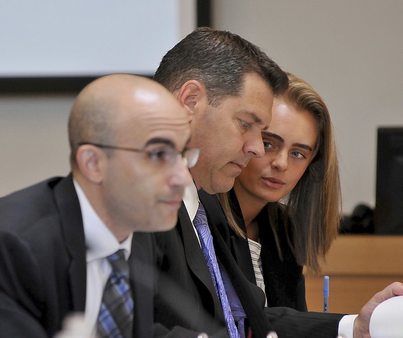 
              Defendant Michelle Carter, right, confers with her lawyer Joe Cataldo, center, as second defense attorney Cory Madera listens to testimonies. The trial of Carter proceeds in Taunton District Court in Taunton, Mass., Wednesday, June 7, 2017. She is charged with involuntary manslaughter for encouraging 18-year-old Conrad Roy, III to kill himself in July 2014. (Mark Stockwell/The Sun Chronicle via AP, Pool)
            