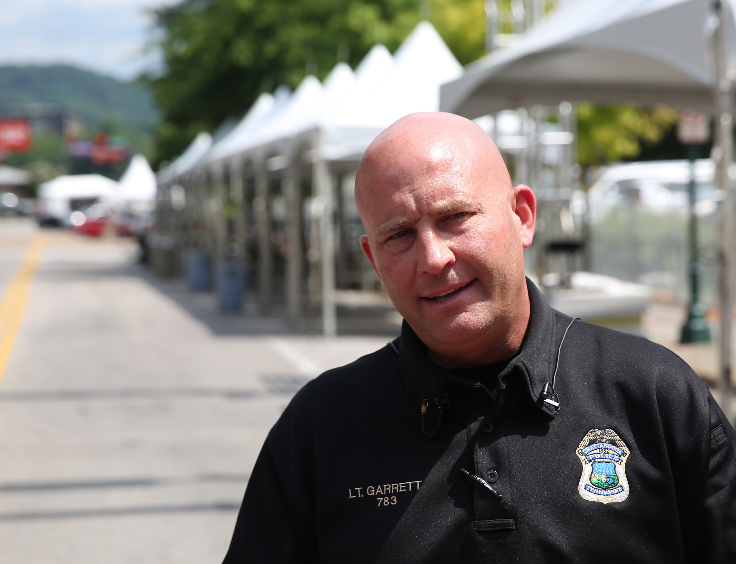 Chattanooga police Lt. Austin Garrett talks about security measures being take this year for the Riverbend Festival during a press conference at the entrance for the Riverbend Festival on Chestnut Street at Aquarium Way in Chattanooga, Tenn., on Thursday, June 8, 2017. For the first time, seven police cameras along the waterfront will be feeding information directly to the new police intelligence center, allowing officers to survey the crowd in real time.