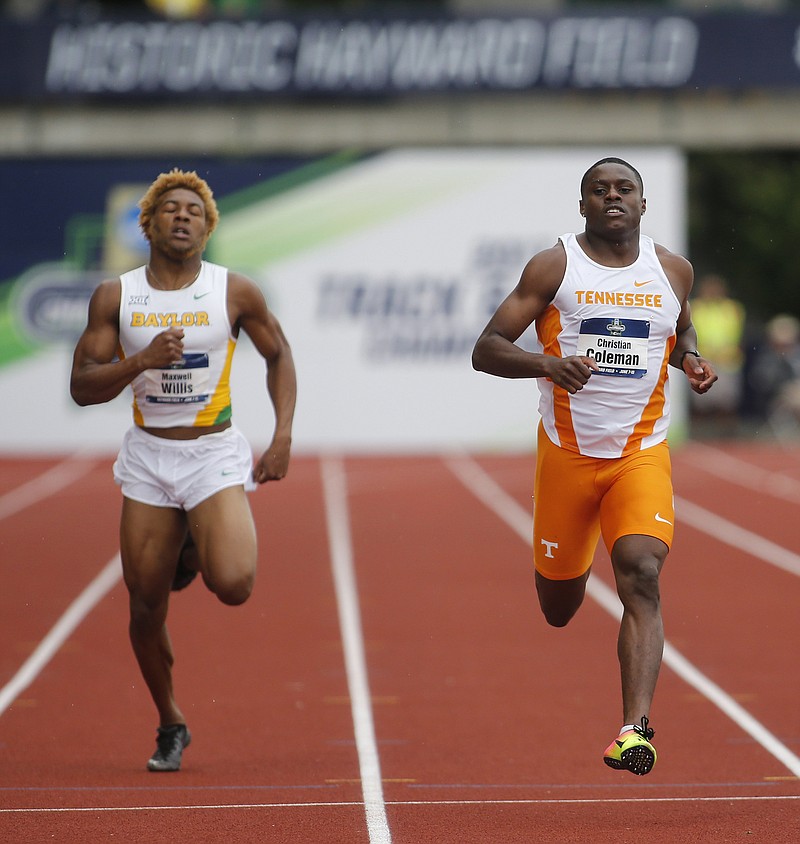 Tennessee's Christian Coleman, right, cruises across the finish line next to Baylor's Maxwell Willis during a 100-meter dash heat Wednesday at the NCAA Division I outdoor track and field championships in Eugene, Ore. Coleman's time of 9.82 seconds set a college record and was the ninth-fastest in history. He will run in the final tonight.