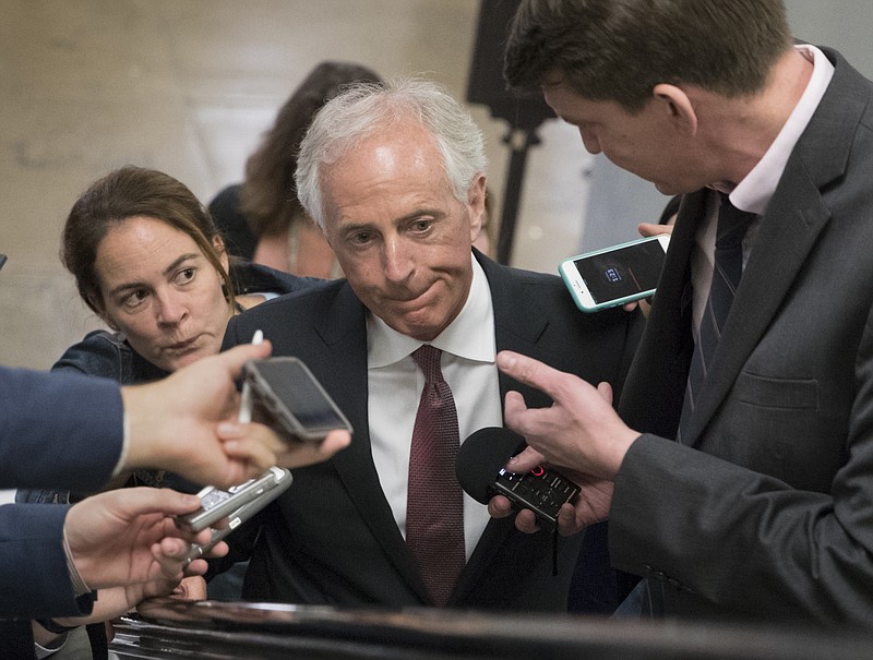 In this May 16, 2017 file photo, Senate Foreign Relations Committee Chairman Sen. Bob Corker, R-Tenn. is surrounded by reporters on Capitol Hill in Washington. The committee overwhelmingly backed bipartisan legislation that would authorize President Donald Trump to put new sanctions on Iran while keeping the landmark nuclear deal with Tehran in place. (AP Photo/J. Scott Applewhite)