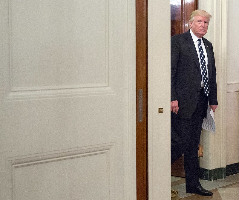 President Donald Trump walks into the State Dinning Room of the White House in Washington to meet with U.S. Mayors and Governors for an Infrastructure Summit, Thursday, June 8, 2017. (AP Photo/Pablo Martinez Monsivais)