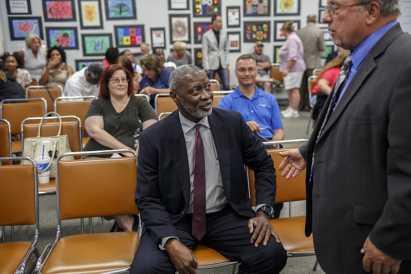 Interim schools superintendent Dr. Kirk Kelly, center, speaks with school board member Dr. Steve Highlander before being introduced at a meet-and-greet with the public in the Hamilton County Board of Education meeting room on Friday, June 9, 2017, in Chattanooga, Tenn. Dr. Kelly was the last of five finalist candidates to interview for the position of Hamilton County schools superintendent.