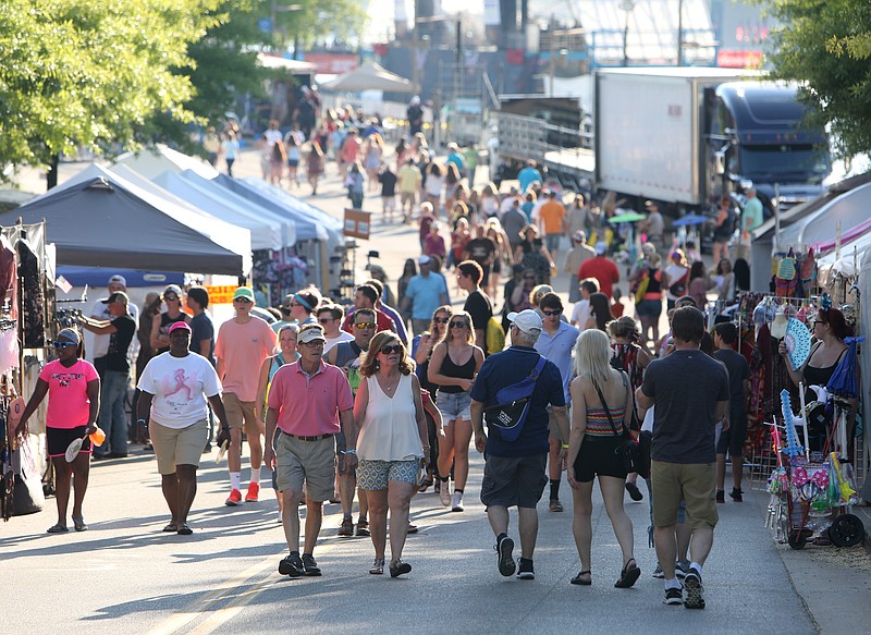 Staff photo by Erin O. Smith / 
Guests look at vendor booths as they walk down Riverfront Parkway on the first night of the Riverbend Festival on Friday, June 9, 2017, in Chattanooga, Tenn. Headliners that played on the Coca-Cola Stage Friday night included The Black Jacket Symphony and Bozz Scaggs.