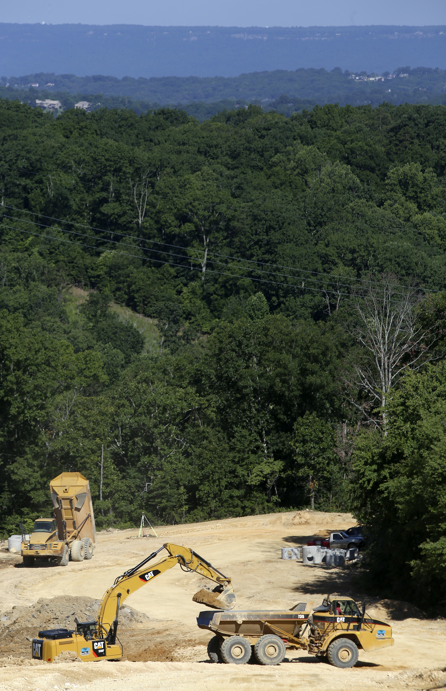 Construction work is performed on an undeveloped part of the Hamilton on Hunter subdivision on Friday, June 9, in Harrison, Tenn.