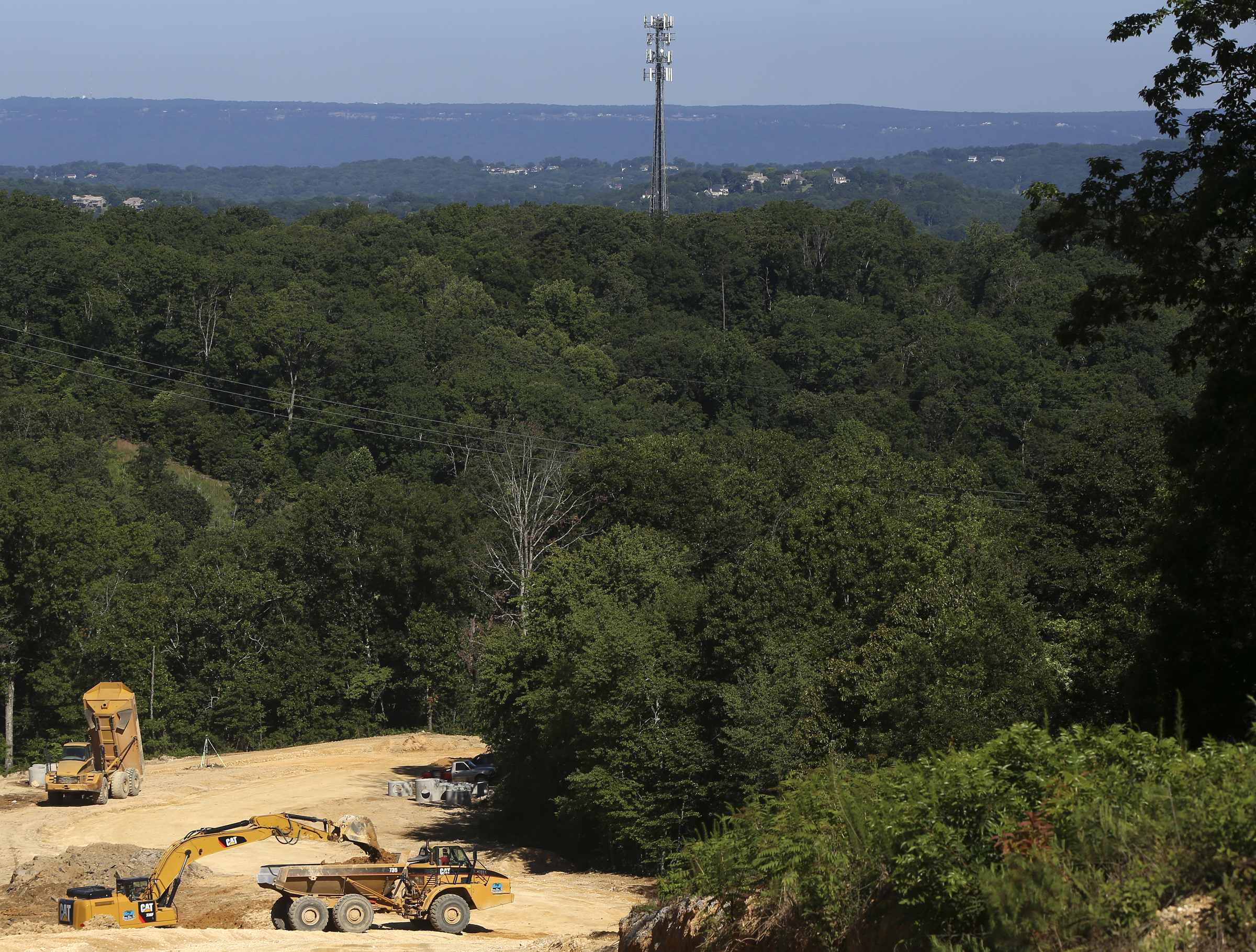 Construction work is performed on an undeveloped part of the Hamilton on Hunter subdivision on Friday, June 9, in Harrison, Tenn.