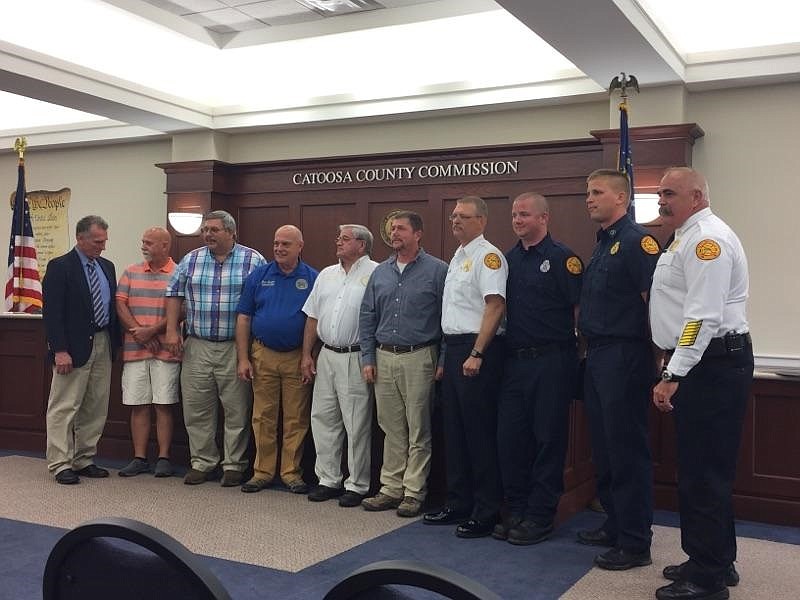 The Catoosa County Commission stands with firefighters and first responders who were on scene the the call that saved Charlie Ramsey's life. Fire Chief Randy Camp personally praised his staff and the Catoosa County School employees that were instrumental in getting Ramsey's heart started again after he suffered a cardiac arrest on April 18.