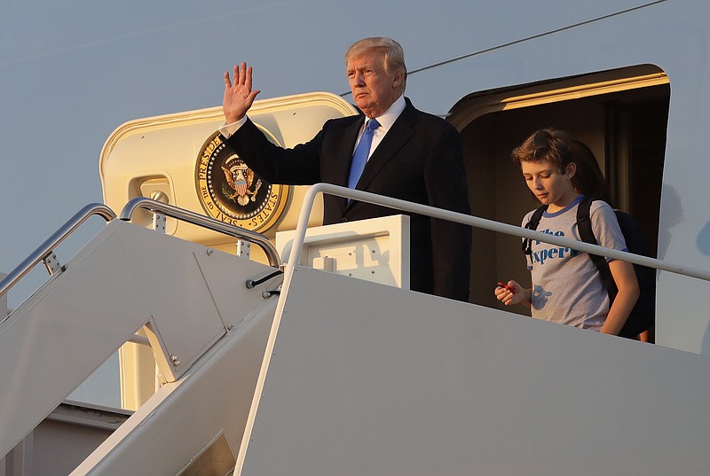 
              President Donald Trump waves in front of his son Barron as he steps off Air Force One after arriving at Andrews Air Force Base, Md., Sunday, June 11, 2017. Trump was returning to Washington after spending the weekend at Trump National Golf Club in Bedminster, N.J. (AP Photo/Patrick Semansky)
            