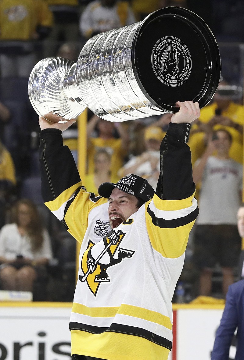 
              Pittsburgh Penguins' Sidney Crosby (87) celebrates with the Stanley Cup after defeating the Nashville Predators in Game 6 of the NHL hockey Stanley Cup Final, Sunday, June 11, 2017, in Nashville, Tenn. (AP Photo/Mark Humphrey)
            