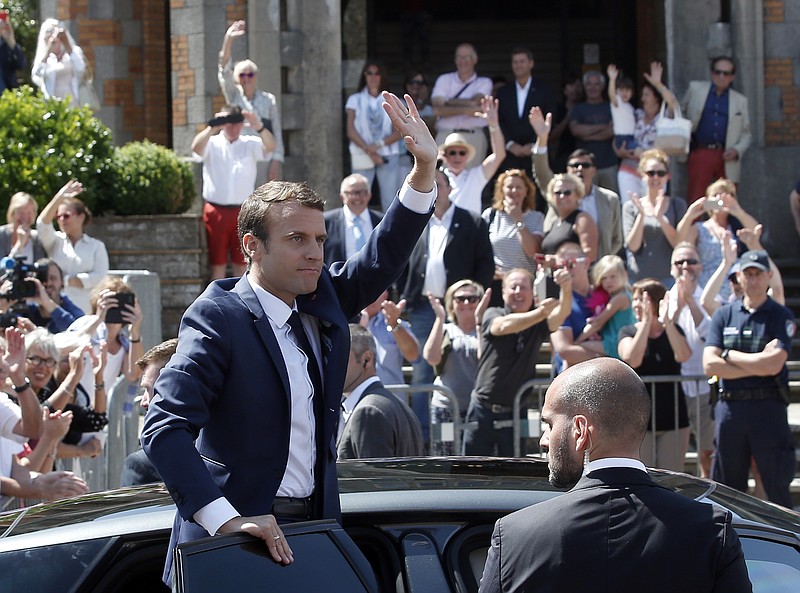 
              French President Emmanuel Macron waves to the audience as he leaves a polling station in Le Touquet, northern France, after casting his vote in the first round of the two-stage legislative elections, Sunday, June 11, 2017. French voters are choosing legislators in the first round of parliamentary elections, with President Emmanuel Macron's party "Republic on the Move" hoping to win a strong majority in the National Assembly to push through bold labor and security reforms. (AP Photo/Thibault Camus)
            