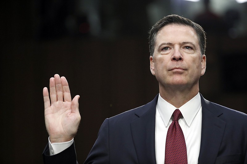 
              Former FBI Director James Comey is sworn in during a Senate Intelligence Committee hearing on Capitol Hill, Thursday, June 8, 2017, in Washington. (AP Photo/Alex Brandon)
            