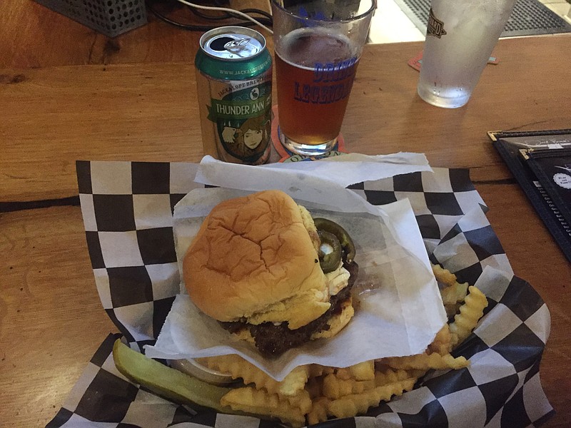 The Jalapeno Popper burger from Jack Brown's, ordered with a side of regular crinkle-cut fries and served with a pickle spear.
