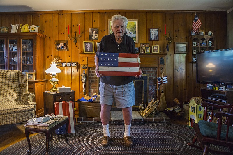Gerald Goldman, 94, who served in World War II in the Marine Corps, began making hand-painted flags for friends and neighbors a few years ago. Goldman's flags have proved popular in his neighborhood, with most of his street now displaying his handiwork outside their homes.