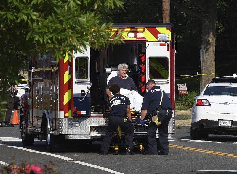 Rep. Roger Williams, R-Texas is placed into an ambulance at the scene of a shooting at a baseball field in Alexandria, Va., Wednesday, June 14, 2017. Members of Congress were practicing for a game when a gunman started shooting. (AP Photo/Kevin S. Vineys)