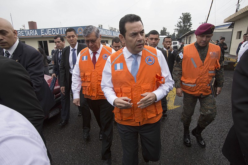 
              Guatemala's President Jimmy Morales, center, arrives to the National Emergency Coordination Agency's headquarters in Guatemala City, Wednesday, June 14, 2017. Morales says two people died in a magnitude 6.9 earthquake in western Guatemala near the border with Mexico on Wednesday. (AP Photo/Moises Castillo)
            