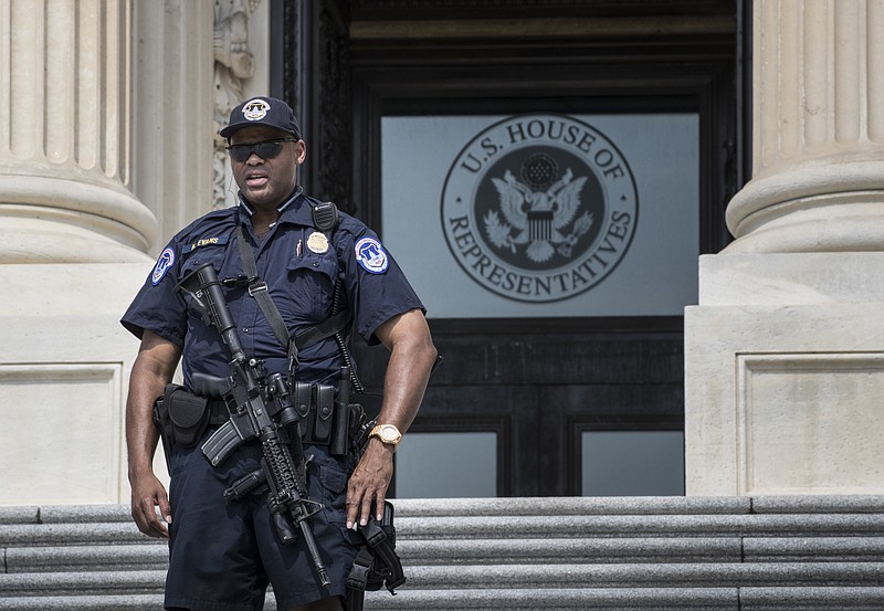 
              A Capitol Hill Police officer stands his post at the entrance to the House of Representatives on Capitol Hill in Washington, Wednesday, June 14, 2017, after House Majority Whip Steve Scalise of La., and others, were injured in a shooting during a congressional baseball practice in Alexandria, Va. (AP Photo/J. Scott Applewhite)
            
