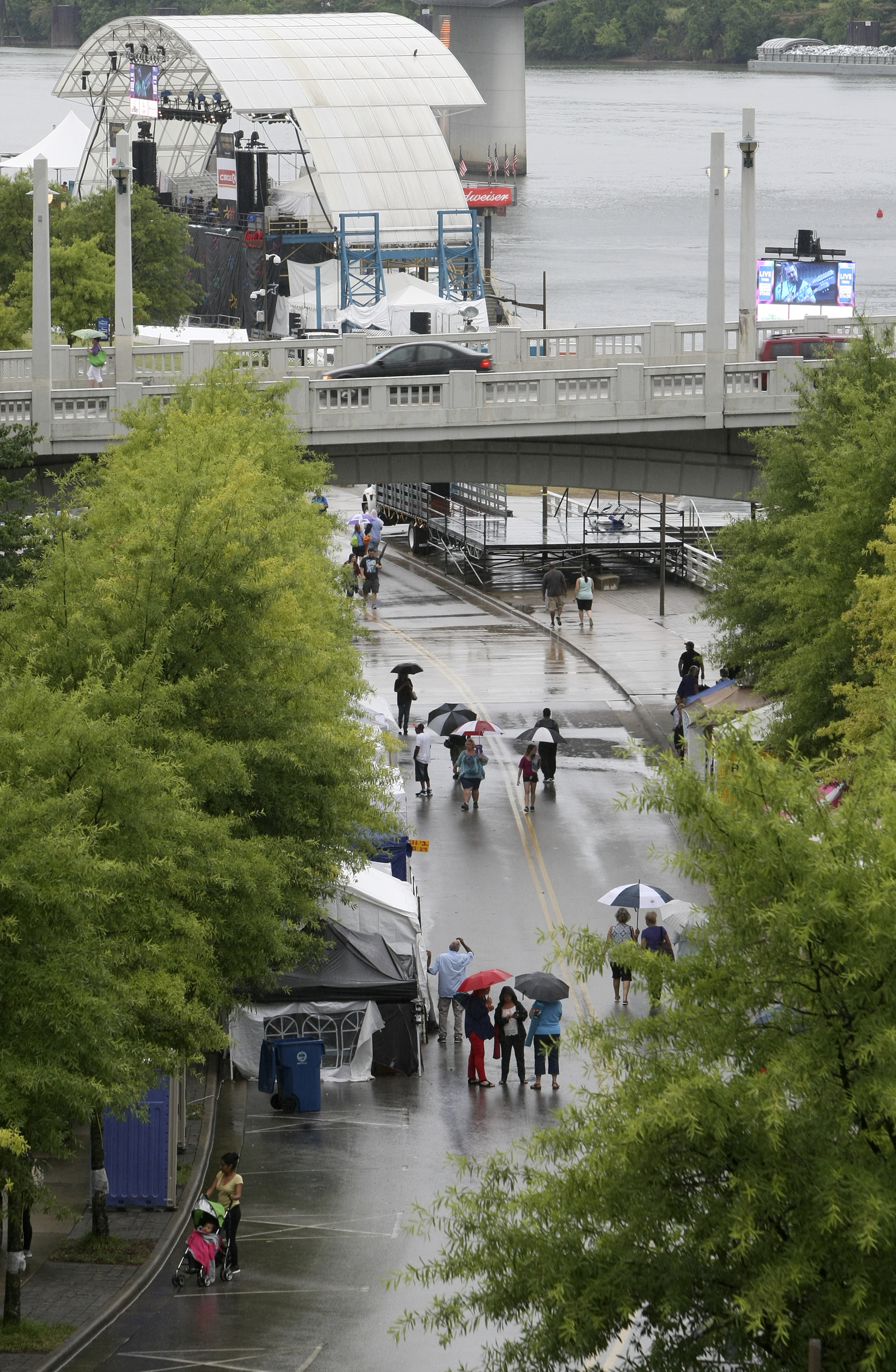 People walk along Riverfront Parkway during the seventh night of the Riverbend Festival at Ross's Landing on Thursday, June 15, in Chattanooga, Tenn. The Coke Stage is seen in the top of the picture.