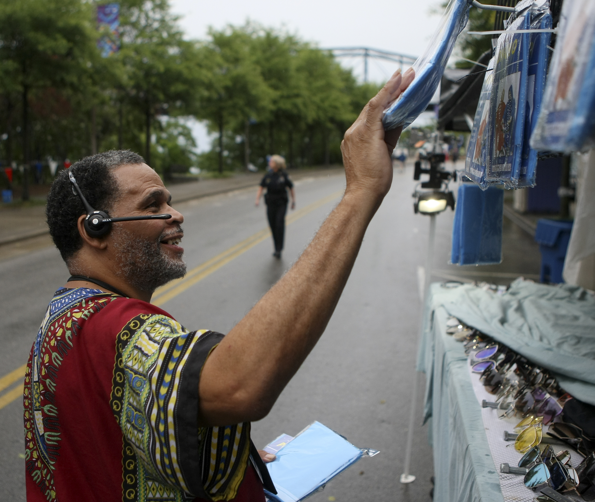 Darrell Harland hangs ponchos up for sale at his booth during the seventh night of the Riverbend Festival at Ross's Landing on Thursday, June 15, in Chattanooga, Tenn. Morris Day and The Time with Cameo headlined the evening.