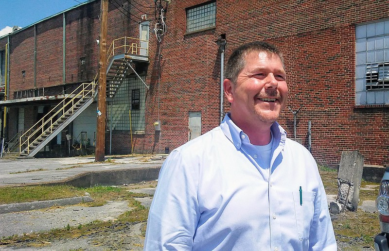 Steven Henry, who runs a Ringgold, Ga.-area construction business that mainly builds homes, stands outside the Peerless Woolen Mills that he bought Thursday for $125,000 at auction.