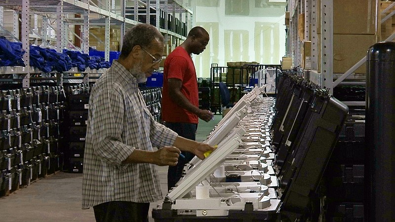 
              FILE - This Sept. 22, 2016 file photo shows employees of the Fulton County Election Preparation Center in Atlanta test electronic voting machines. A security researcher disclosed a gaping security hole at the outfit that manages Georgia's elections. The lapse, which left the state’s 6.7 million voter records and other sensitive files exposed to hackers, was first reported Wednesday, June 14, 2017, by the news site Politico. (AP Photo/Alex Sanz)
            
