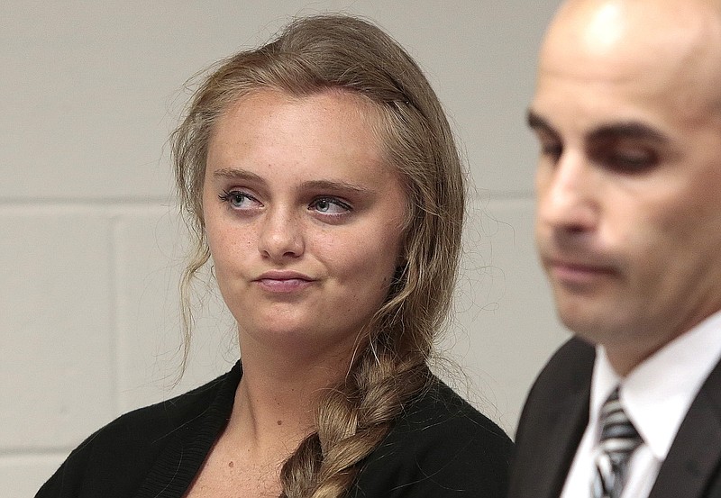 
              FILE - In this Aug. 24, 2015 file photo, Michelle Carter listens to defense attorney Joseph P. Cataldo argue for an involuntary manslaughter charge against her to be dismissed at Juvenile Court in New Bedford, Mass. Carter is charged with involuntary manslaughter for allegedly pressuring Conrad Roy III, 18, of Fairhaven, Mass., to commit suicide on July 13, 2014. Judge Lawrence Moniz is deliberating Carter's fate following a jury-waived trial that provided a disturbing look at teen depression and suicide. It is not clear when the judge will issue his verdict. (Peter Pereira/The New Bedford Standard Times via AP, Pool, File)
            