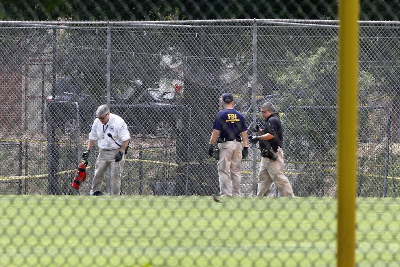 
              FBI agents continue to search for evidence on the baseball field in Alexandria, Va., Thursday, June 15, 2017, the day after House Majority Whip Steve Scalise of La. was shot during during a congressional baseball practice. (AP Photo/Jacquelyn Martin)
            