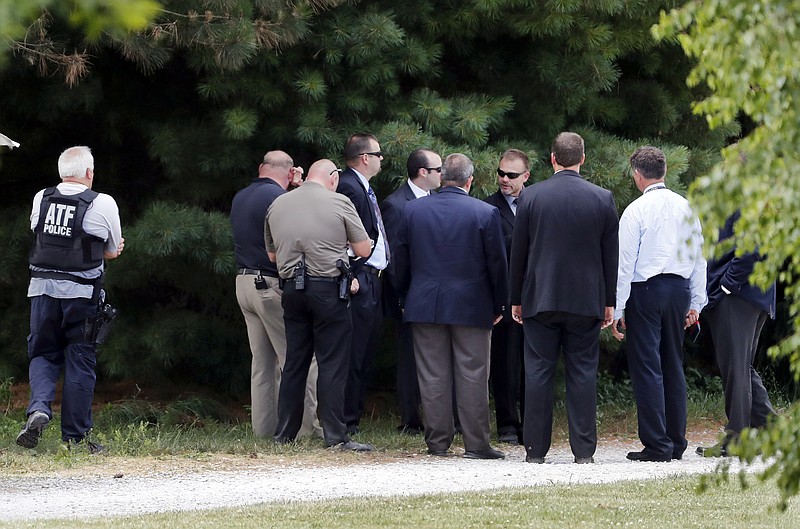 
              Law enforcement talk while investigating outside the home of James T. Hodgkinson on Wednesday, June 14, 2017, in Belleville, Ill. Officials said Hodgkinson has been identified as the man who opened fire on Republican lawmakers at a congressional baseball practice Wednesday morning in Alexandria, Va. (AP Photo/Jeff Roberson)
            