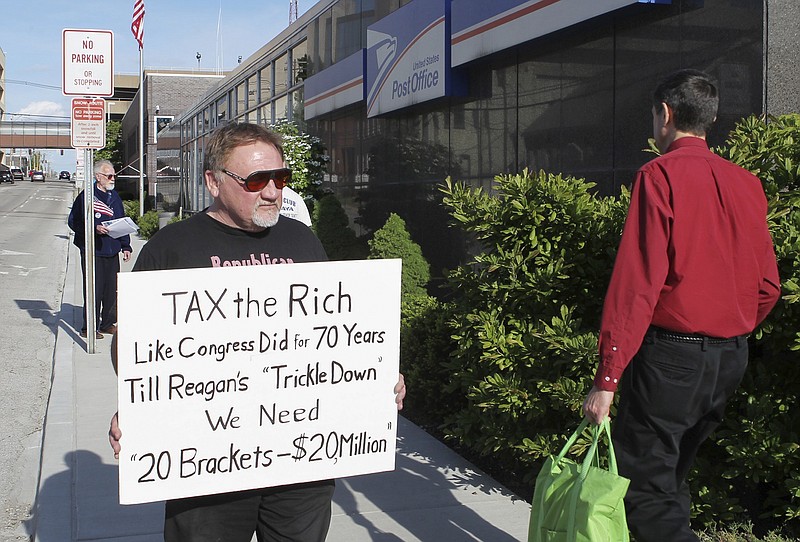 
              FILE - In this April 17, 2012, photo, James Hodgkinson of Belleville protests outside of the United States Post Office in Downtown Belleville, Ill. A government official says the suspect in the Virginia shooting that injured Rep. Steve Scalise and several others has been identified Hodgkinson. (Derik Holtmann/Belleville News-Democrat, via AP)
            