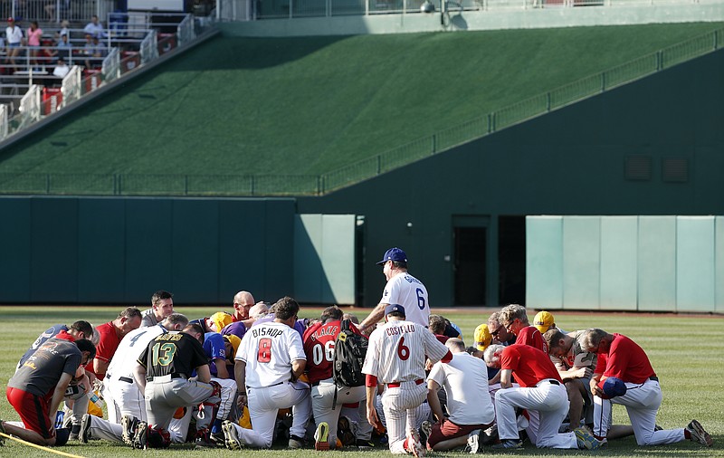 Steve Garvey, former Los Angeles Dodgers player, leads a prayer for the Republican team before the Congressional baseball game, Thursday, June 15, 2017, in Washington. The annual GOP-Democrats baseball game raises money for charity. (AP Photo/Alex Brandon)

