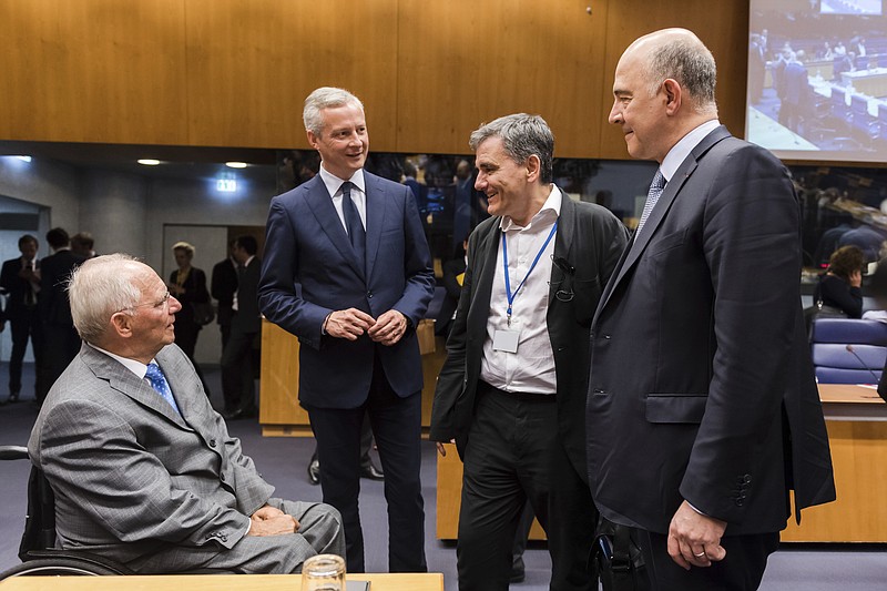 
              German Finance Minister Wolfgang Schaeuble, left, speaks with from right, European Commissioner for Economy Pierre Moscovici, Greek Finance Minister Euclid Tsakalotos, and French Finance Minister Bruno Le Maire during a meeting of eurogroup finance ministers at the European Council building in Luxembourg on Thursday, June 15, 2017. Eurogroup finance ministers met on Thursday to review the bailout program for Greece. (AP Photo/Geert Vanden Wijngaert)
            