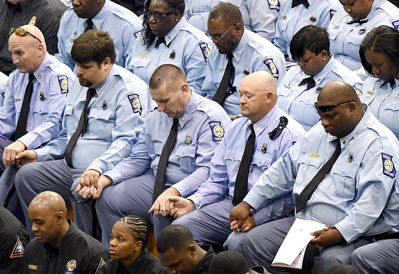 
              Georgia corrections officers hold hands while praying during funeral services for corrections officer Sgt. Curtis Billue, Saturday, June 17, 2017 in McIntyre, Ga. Billue who was killed while transporting inmates was a hero who spent his career protecting other people, Georgia's top prison official said at the man's funeral. (Jason Vorhees/The Macon Telegraph via AP)
            