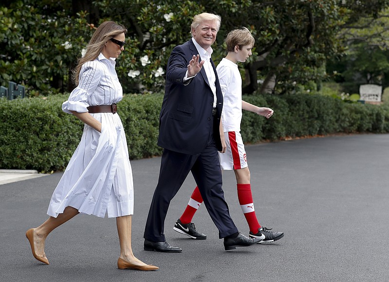 
              President Donald Trump, first lady Melania Trump, and their son and Barron Trump, walk to Marine One across the South Lawn of the White House in Washington, Saturday, June 17, 2017, en route to Camp David in Maryland. (AP Photo/Carolyn Kaster)
            