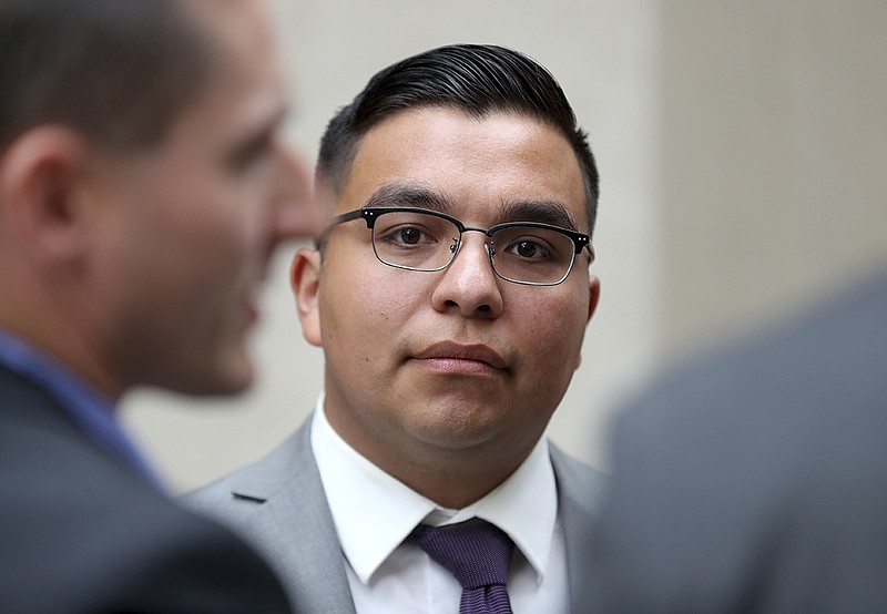 FILE - In this May 30, 2017, file photo, St. Anthony police officer Jeronimo Yanez stands outside the Ramsey County Courthouse while waiting for a ride in St. Paul, Minn. Closing arguments are set for Monday, June 12, in a Minnesota police officer's manslaughter trial in the death of a black motorist. (David Joles/Star Tribune via AP, File)