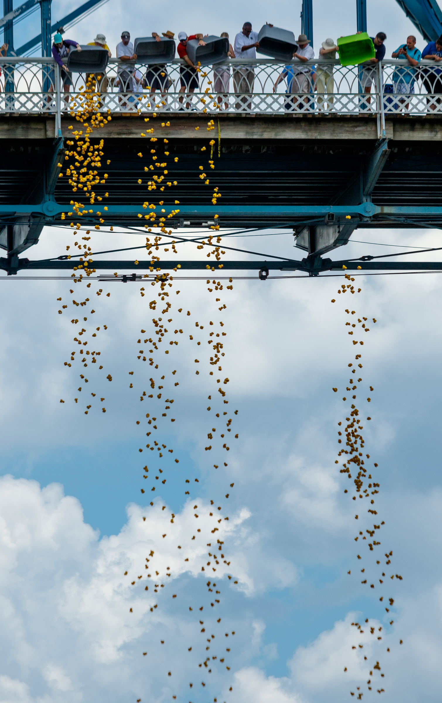Thousands of rubber ducks are dumped from the Walnut Street Bridge to start the Great Kiwanis Duck Race on the Tennessee River on Saturday, June 17, 2017, in Chattanooga, Tenn. The ducks drifted with the current downstream in a race to the finish, and proceeds for entries benefitted the Children's Advocacy Center of Hamilton County.
