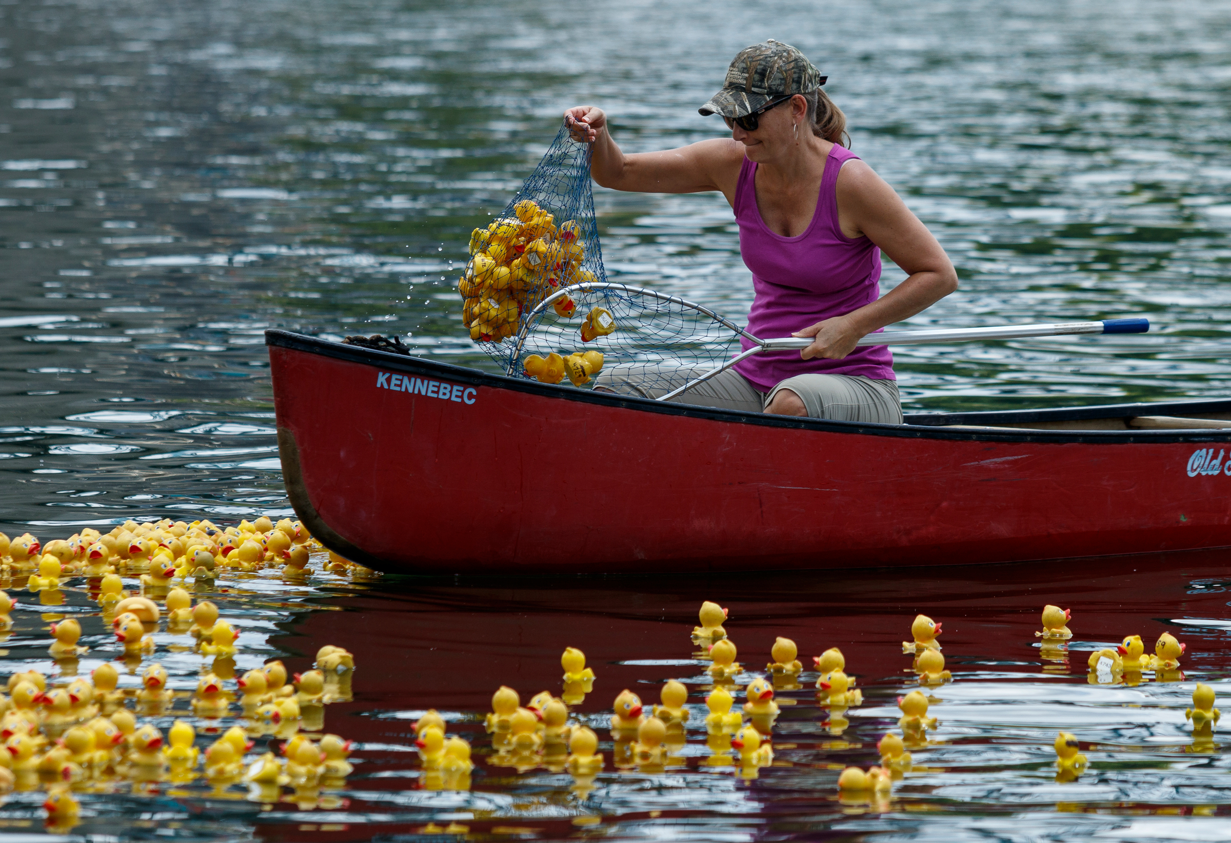 A volunteer fishes rubber ducks out of the Tennessee River after the Great Kiwanis Duck Race on Saturday, June 17, 2017, in Chattanooga, Tenn. Thousands of rubber ducks were dropped from the Walnut Street Bridge to drift with the current downstream in a race to the finish, and proceeds for entries benefitted the Children's Advocacy Center of Hamilton County.
