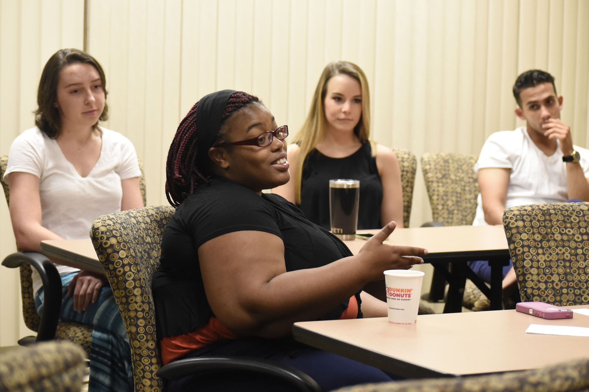 D'Onna Hammond, foreground, talks about her experiences with the Global Scholars program, while fellow scholars, from left, Cameron